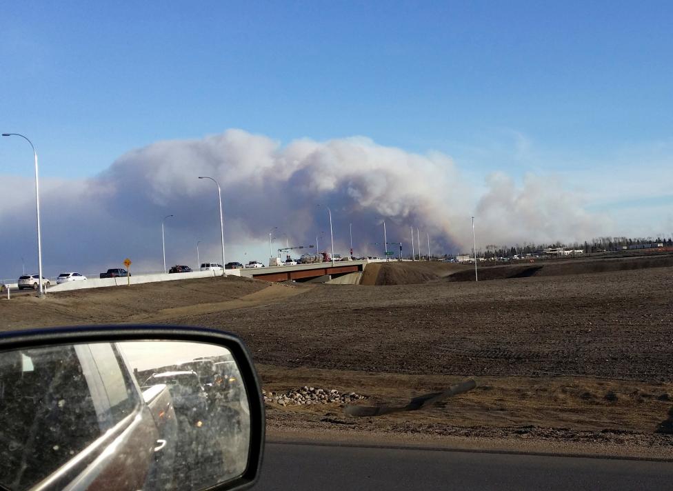 Vehicles are seen on highway 63 as they are detoured near wildfire burning near Fort McMurray Alberta